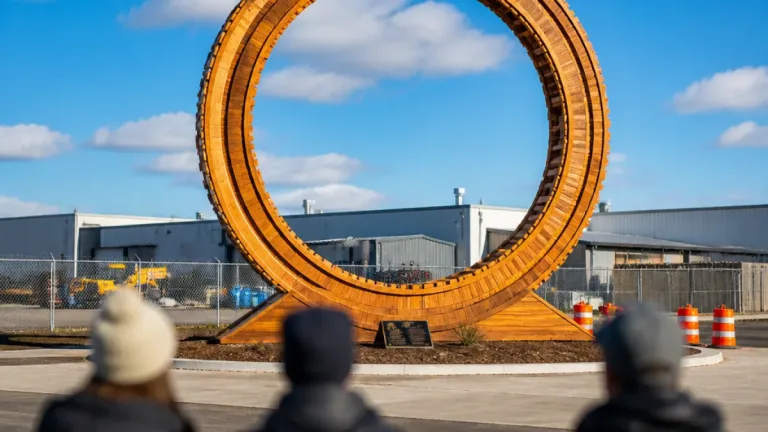 25-foot wooden toy train installed as gateway artwork in St. Thomas industrial park