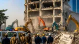 Noida authority tears down five‑storey unauthorised complex in Sector 104 Hajipur